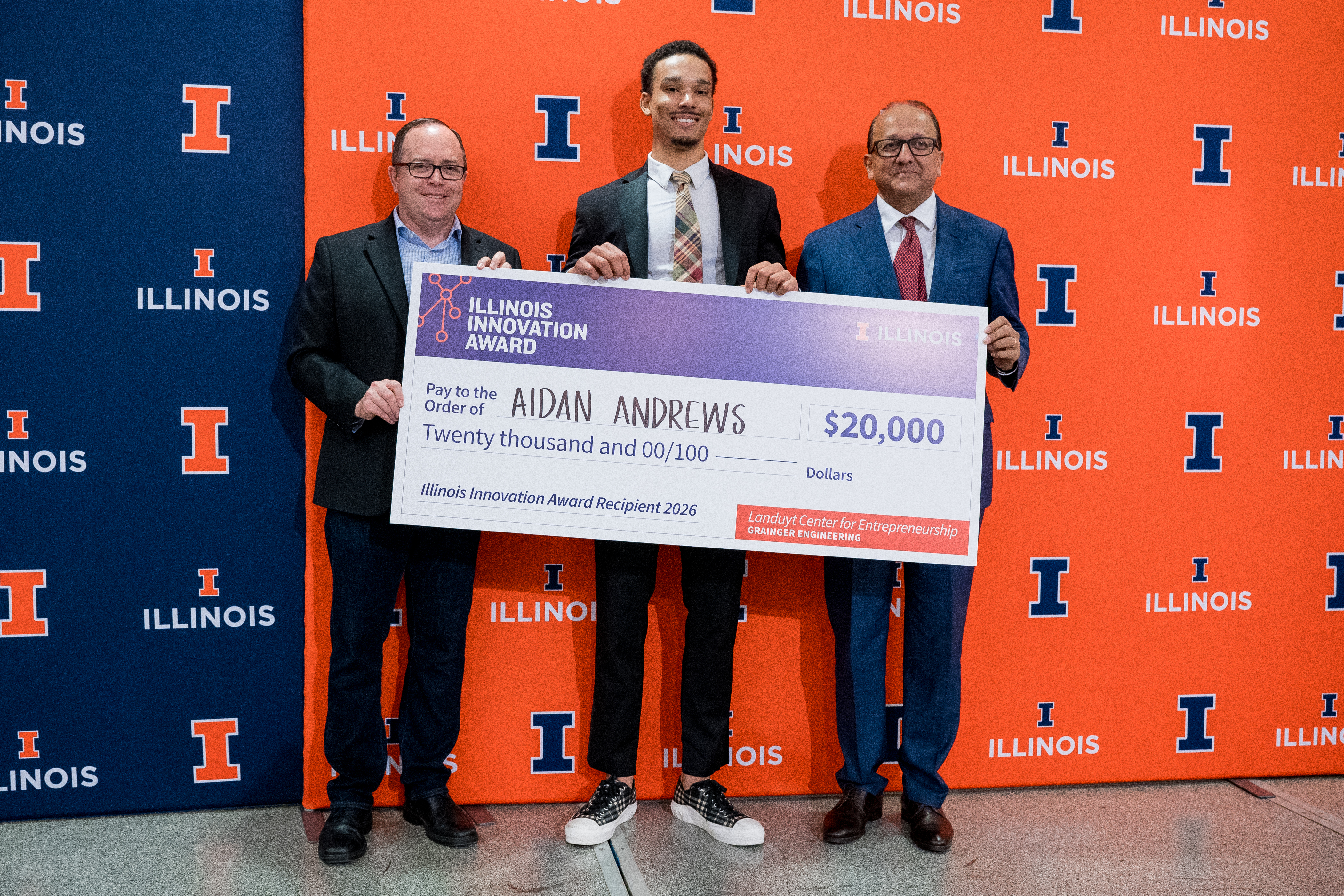 Illinois Innovation Award recipeint receiving the check from campus leadership.